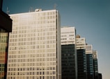 Corporate office buildings in São Paulo under a clear blue sky.