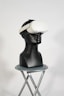a black mannequin with a white hat on top of it