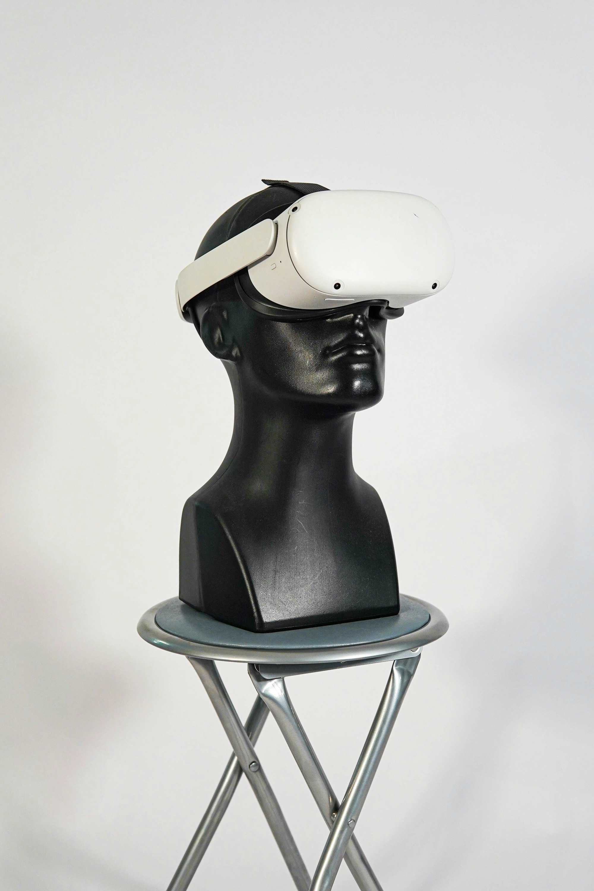 a black mannequin with a white hat on top of it