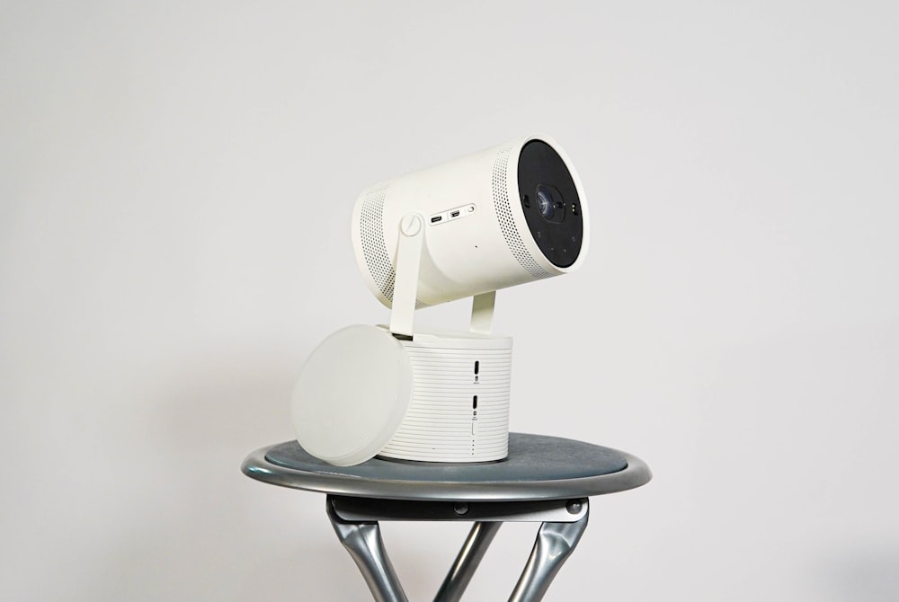 a white camera sitting on top of a table