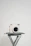Close-up of a minimalist sliding photo book holding colorful Instax prints on a clean white desk.
