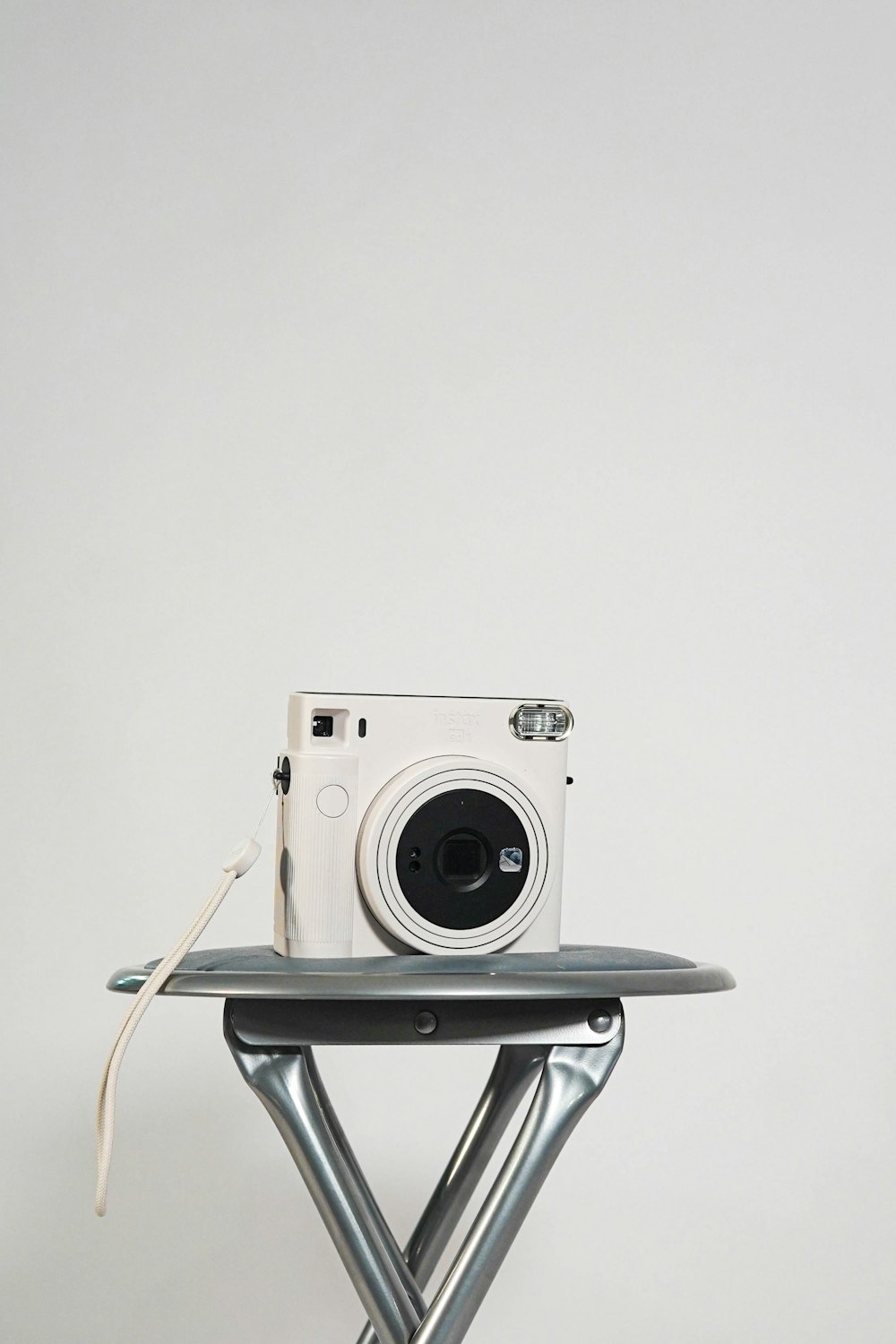 a white camera sitting on top of a table
