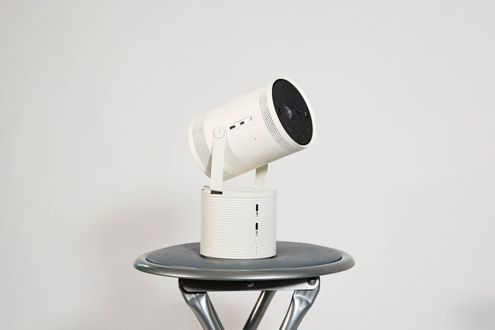 Una telecamera bianca seduta sopra un tavolo