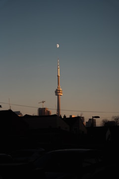City skyline at dusk with illuminated communication towers.