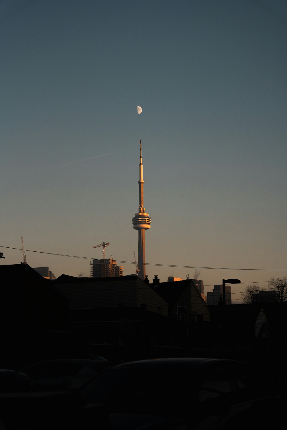 a view of a tall building with a moon in the sky