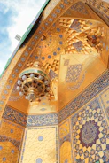 A beautifully painted traditional Arabic majlis with intricate ceiling designs.