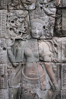 a close up of a stone wall with carvings on it