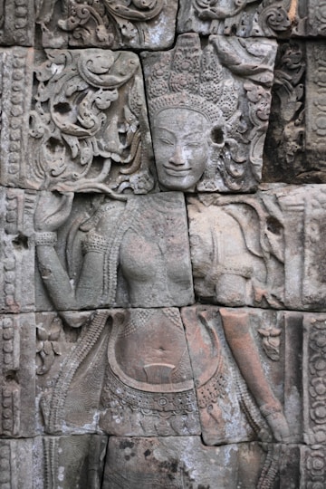 a close up of a stone wall with carvings on it