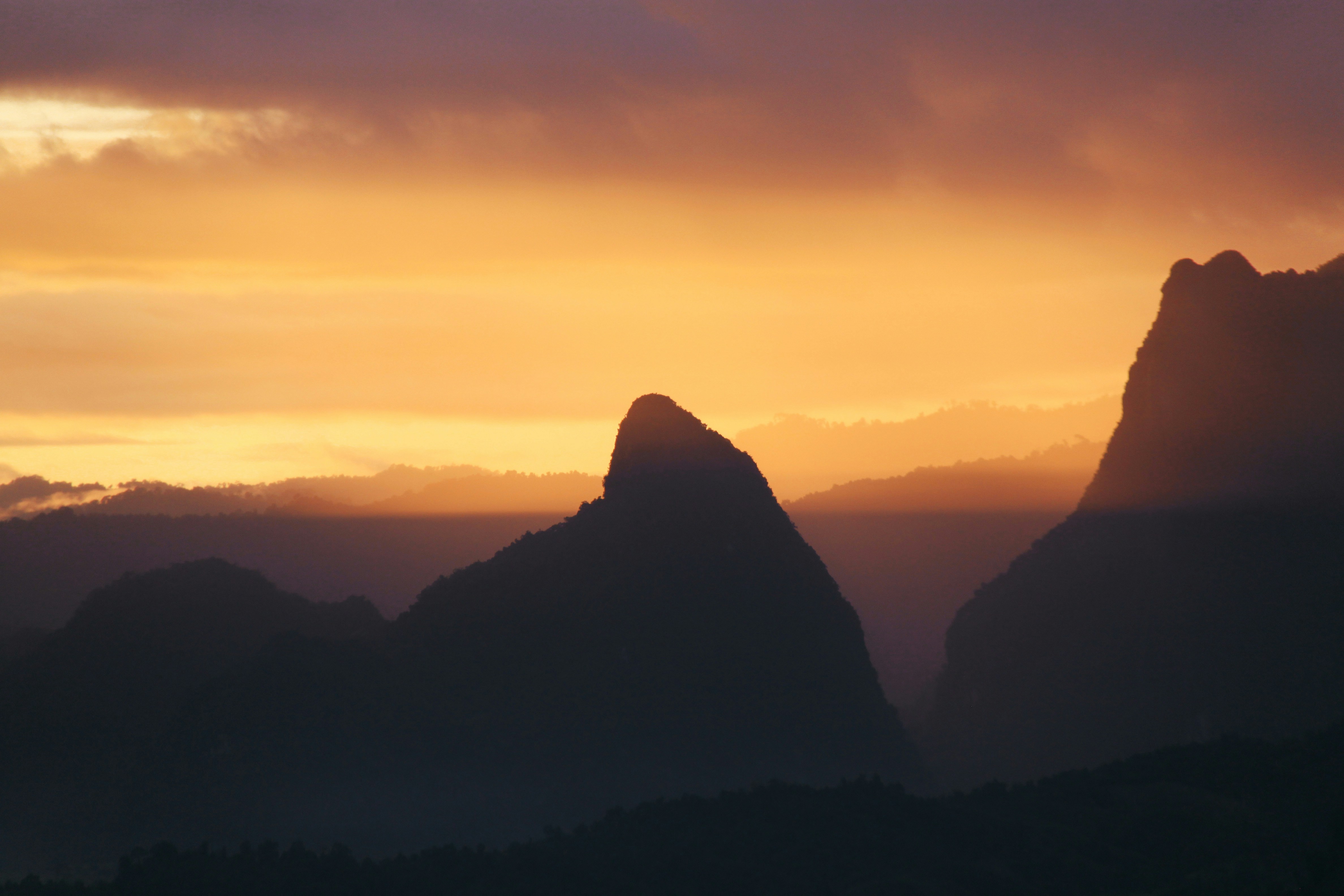 the sun is setting behind a mountain range, Pha Ngern View Point at Sunset
