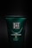 A dark green bottle of 'The Ritual of Jing' with text emphasizing its purpose of providing a path to inner peace. The branding is elegant with gold and white lettering, offering a sense of luxury and tranquility.