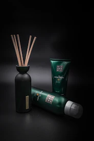 Assorted personal hygiene sprays and lotions arranged with natural elements.