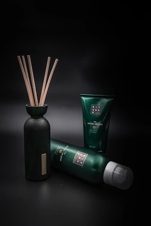 Luxurious dark green and gold branded herbal shampoo bottles arranged elegantly.