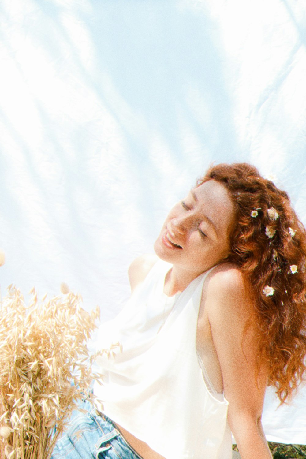 a woman with red hair standing in a field