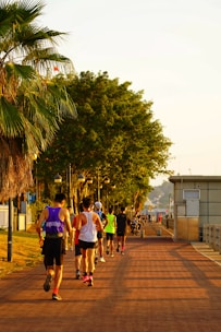 A vibrant photo of a diverse group of adults enjoying a morning jog in a park.