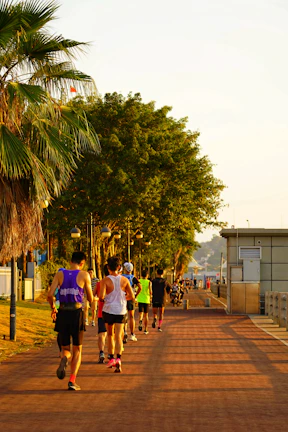 Group of friends jogging through a park, energized and focused in vibrant sportswear