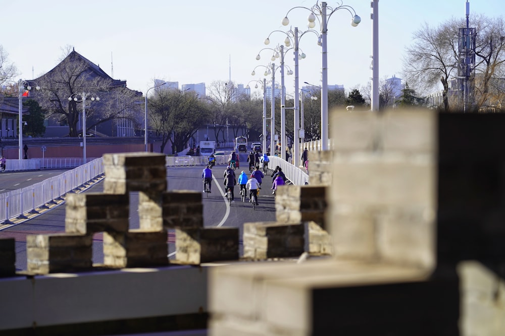 a group of people riding bikes down a street