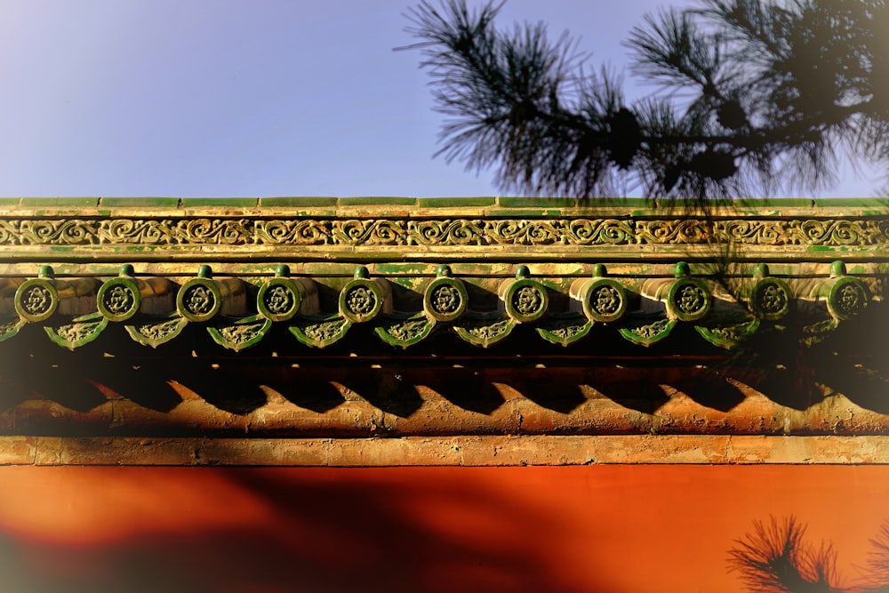 a close up of a roof with a pine tree in the background