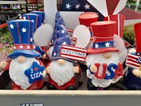 A patriotic display of hats and shirts for sale.