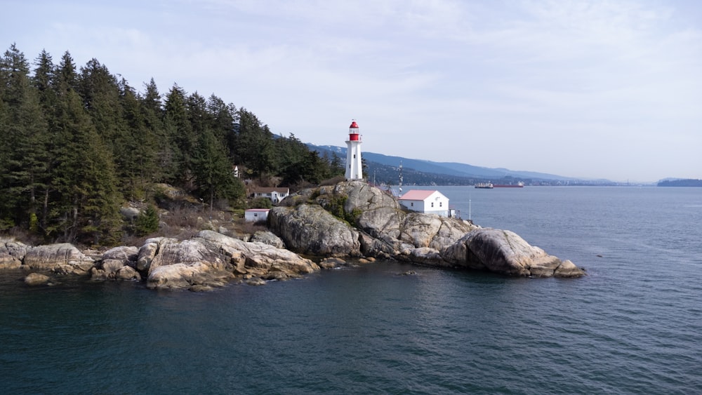 a light house sitting on top of a rocky island