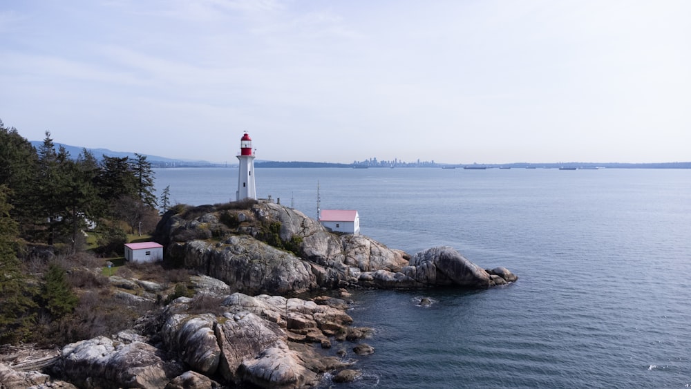 a light house sitting on top of a cliff next to the ocean