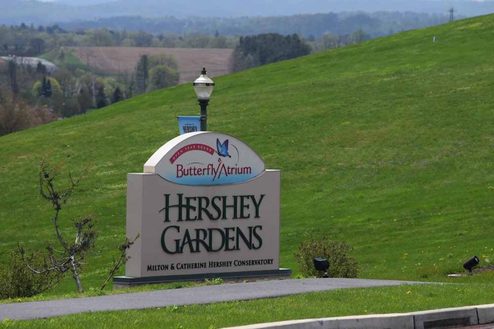 a sign that is in front of a grassy hill