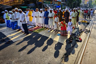 a group of people standing on the side of a road