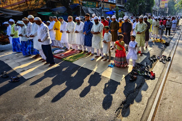 a group of people standing on the side of a road