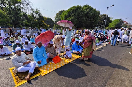 Community members gathered in a mosque courtyard participating in a charity event.