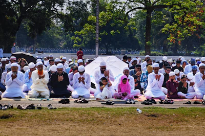 A group prayer session taking place outdoors with church members and guests.