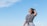 a woman standing in a field with a frisbee in her hand