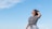 a woman standing in a field with a frisbee in her hand