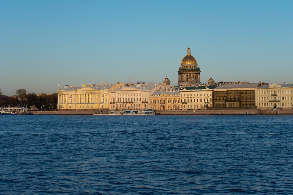 a large body of water with buildings in the background