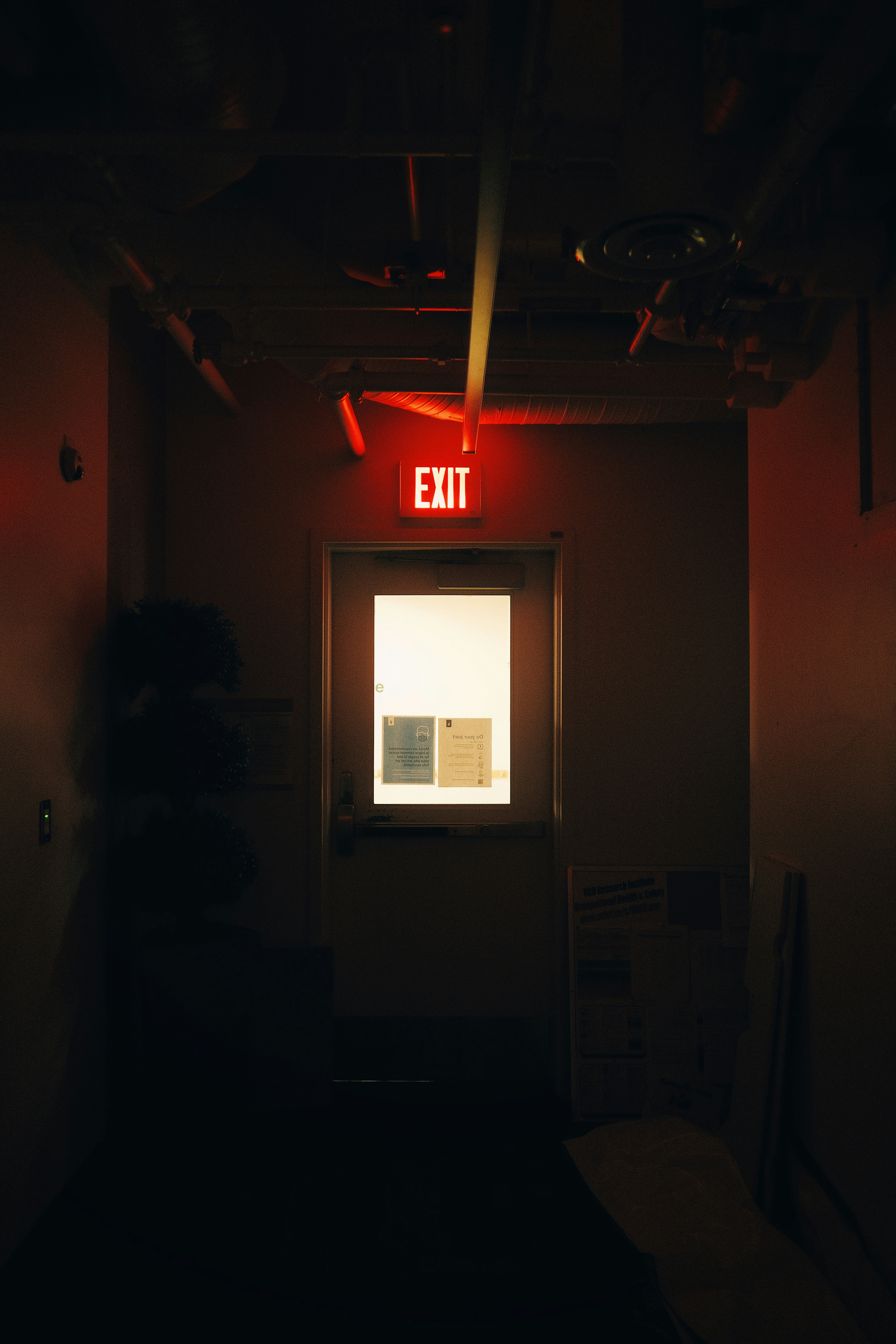 the exit sign is lit up in the dark