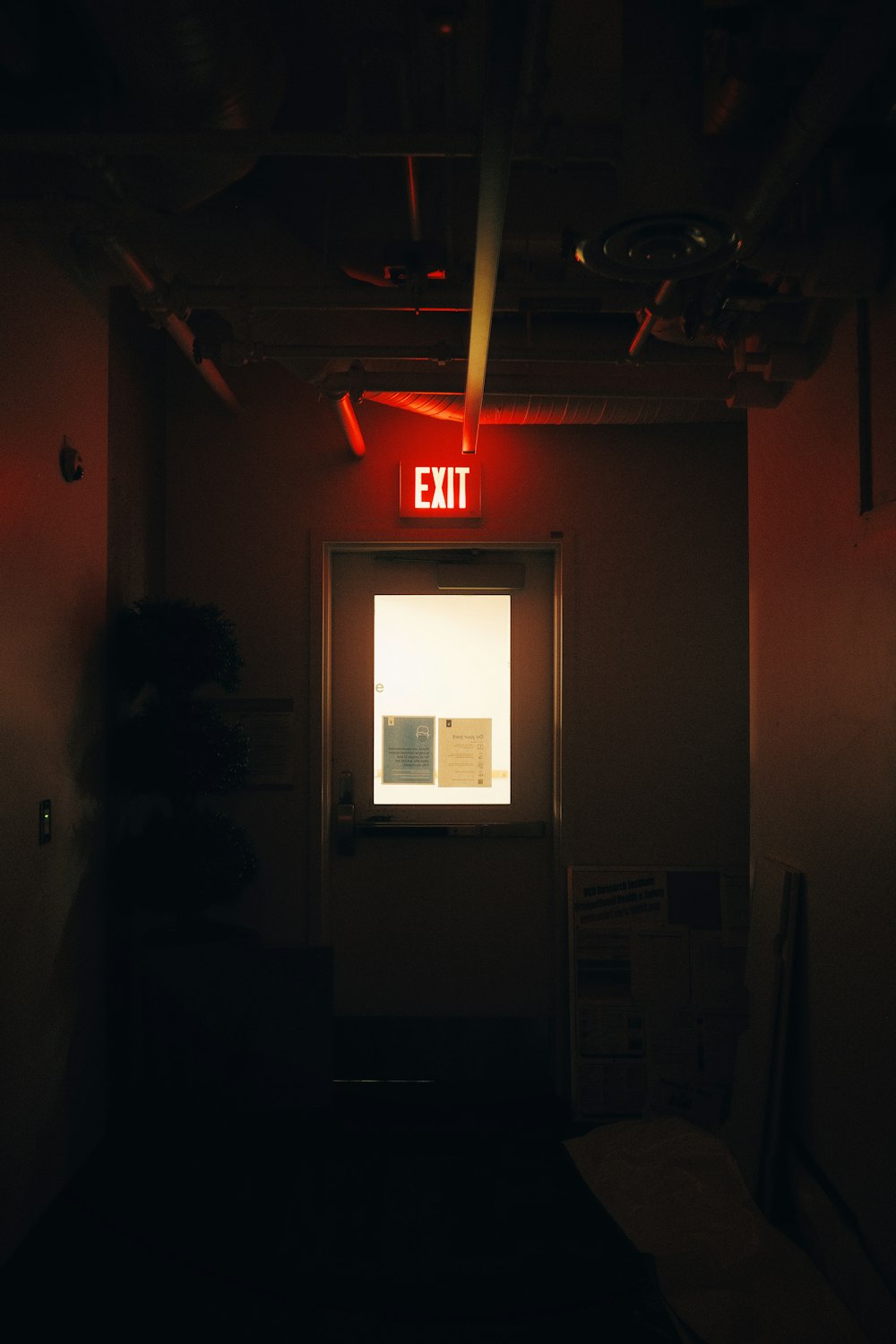the exit sign is lit up in the dark