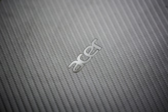 A close-up of a custom business mat with a vibrant company logo woven into the fabric.