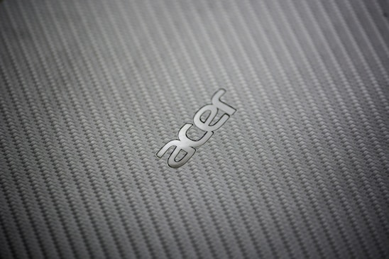 A close-up of a custom business mat with a vibrant company logo woven into the fabric.