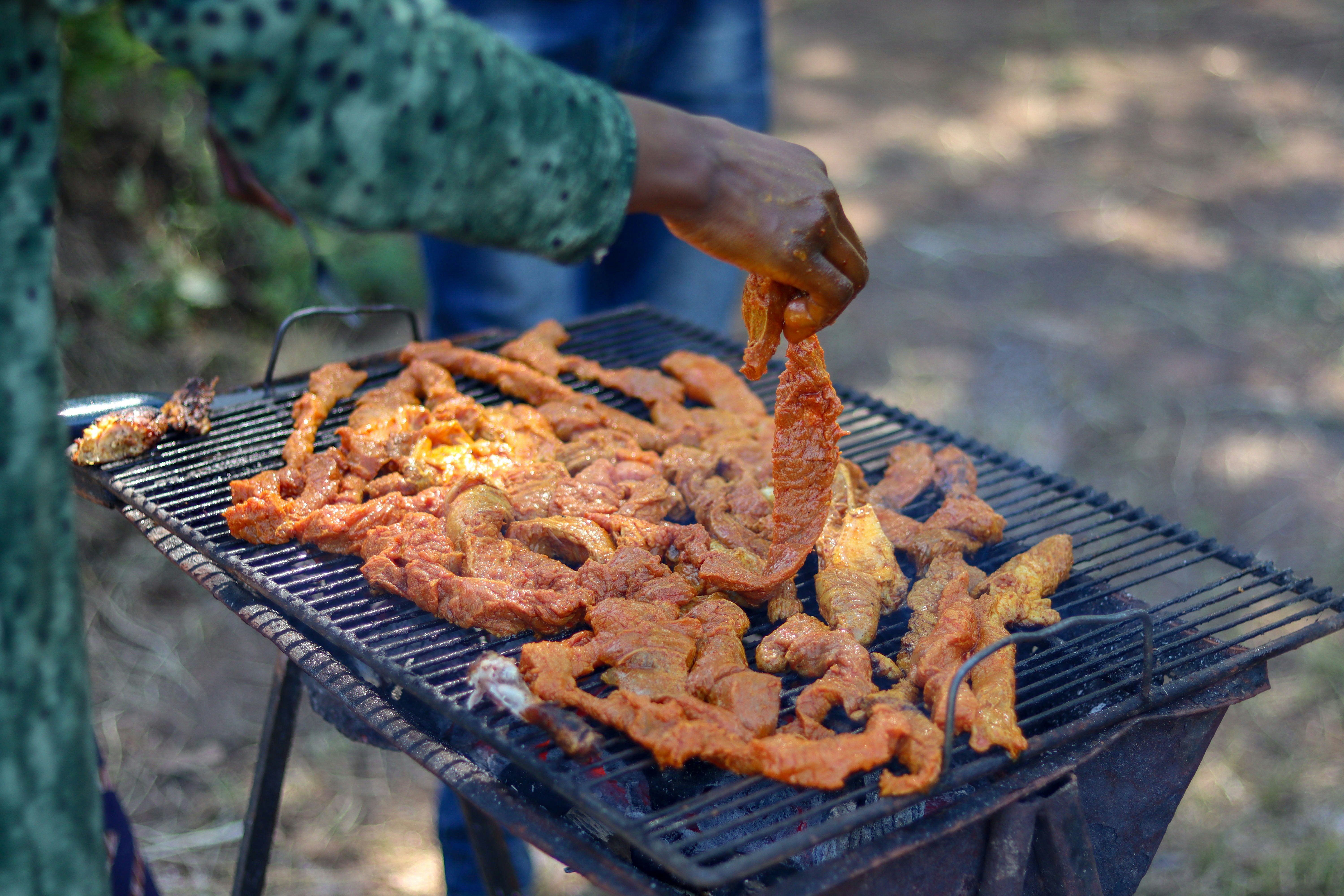 a person is cooking food on a grill