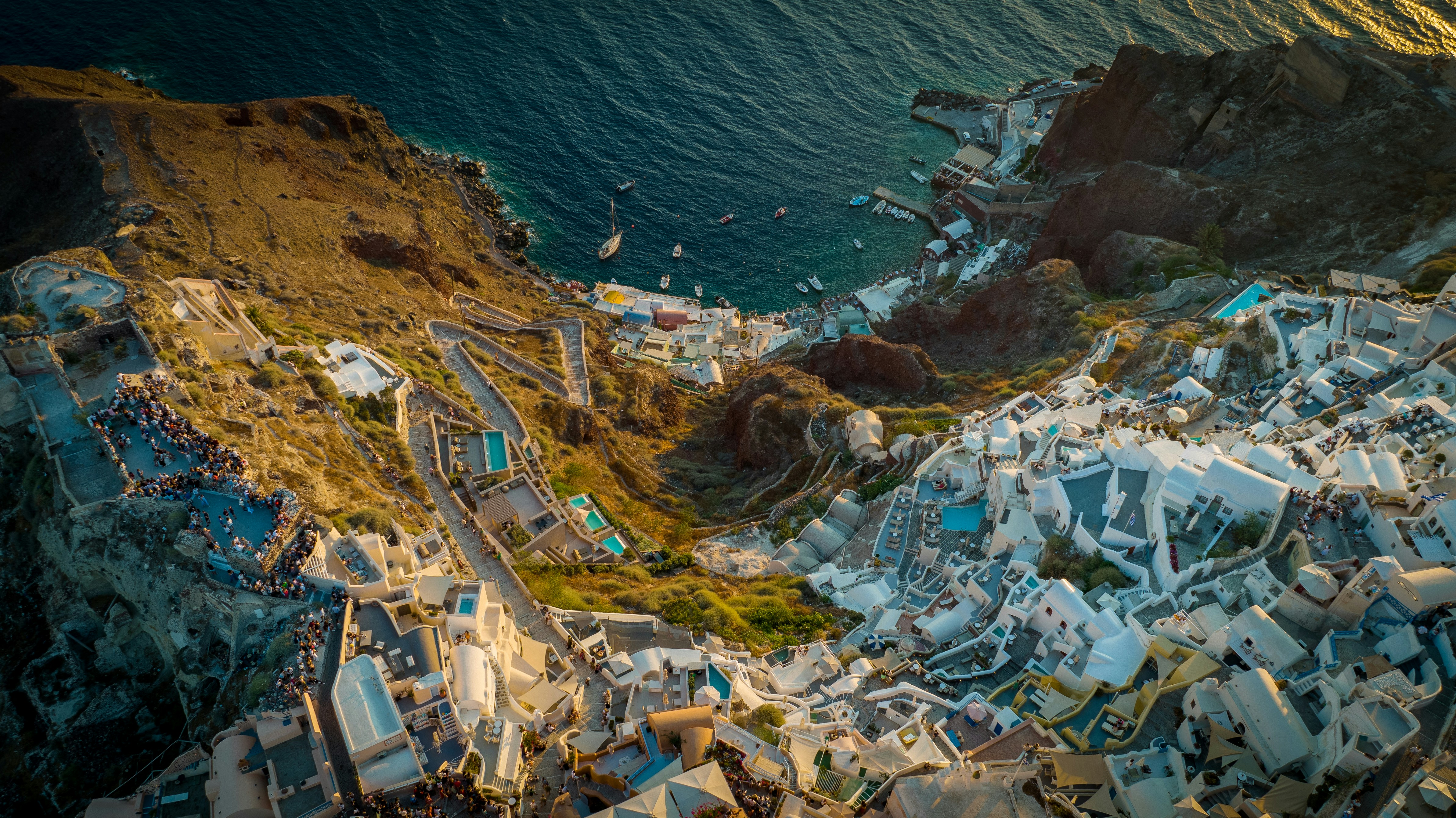 an aerial view of a city next to the ocean