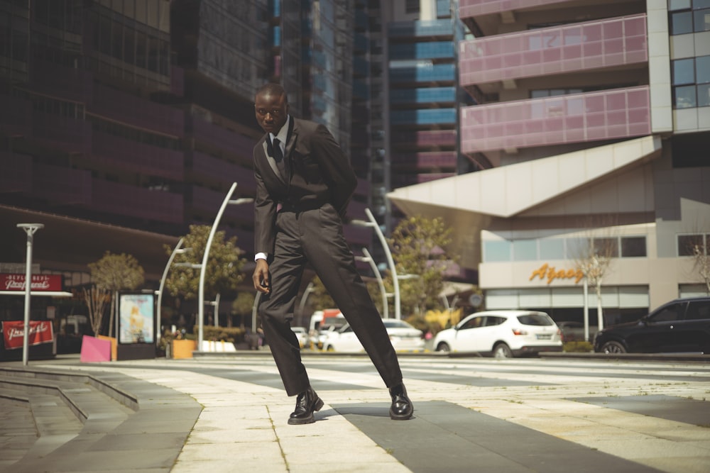 a man in a suit is kicking a soccer ball