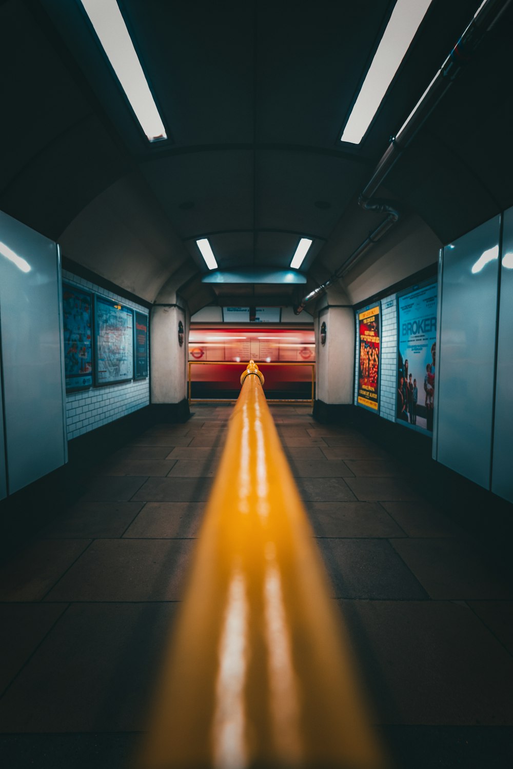 a long yellow line in a subway station