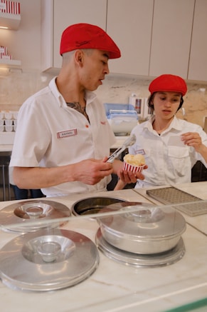 a man and a woman preparing food in a kitchen