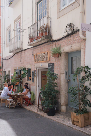 A cozy café terrace in Toledo with people sipping coffee and chatting.
