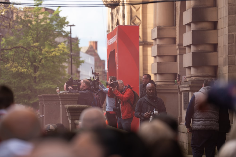 a group of people standing on a street corner