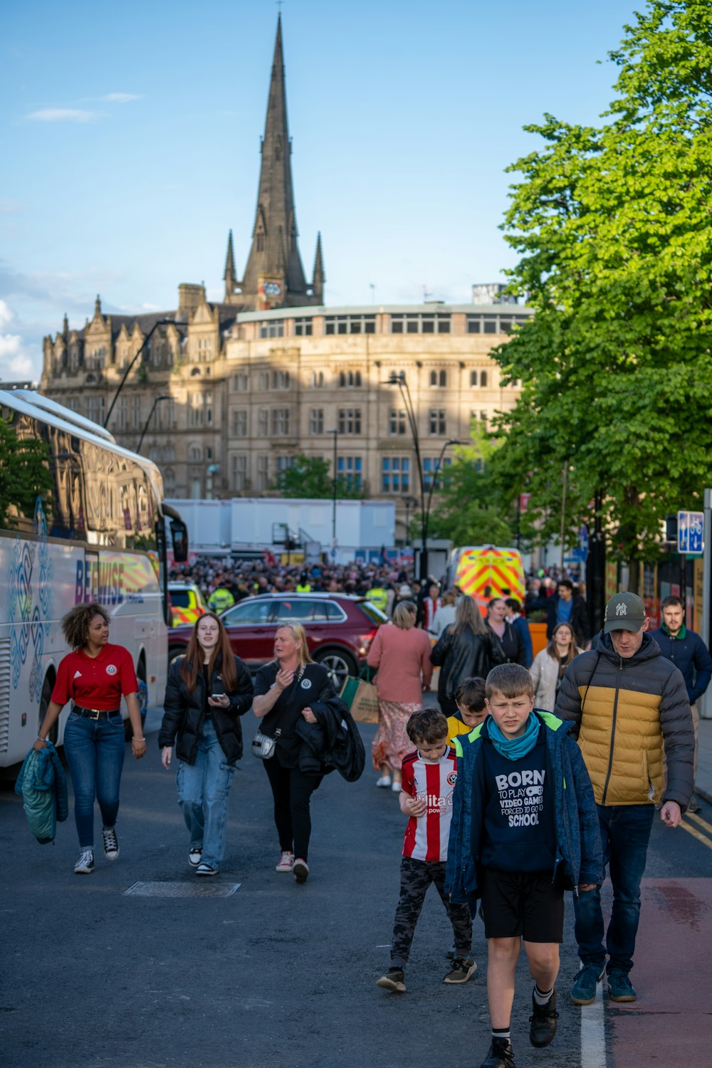 a group of people walking across a street