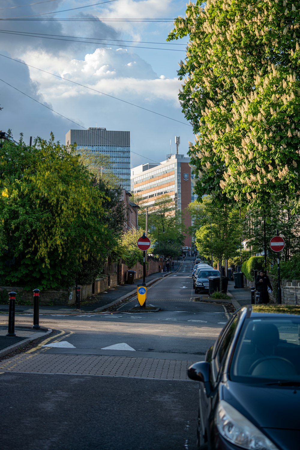 a city street with cars parked on the side of the road