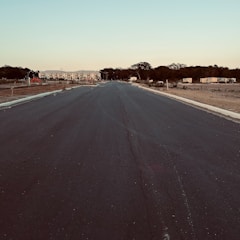 Wide shot of a freshly paved road stretching into the distance.