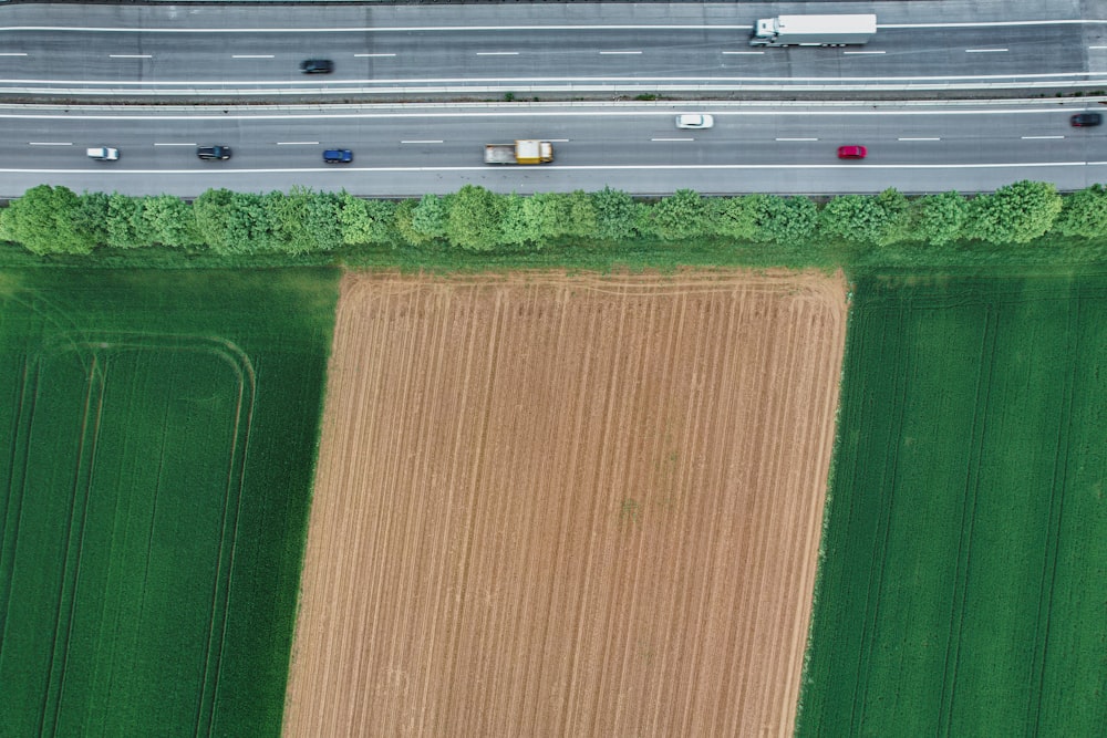 an aerial view of a road and a field