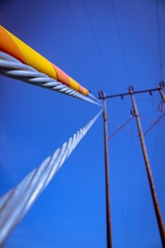 Detail of transmission lines against a clear blue sky.