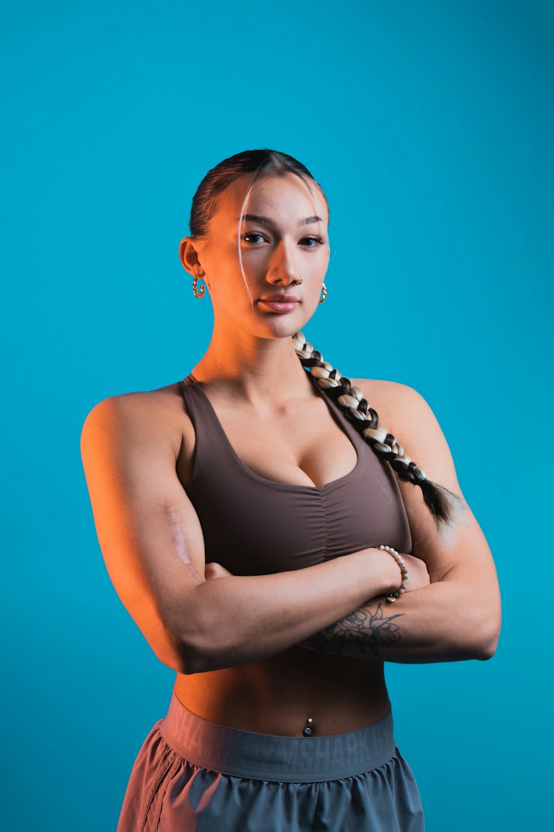 Jordan Kim, Post-Rehab Specialist at FitForge, arms crossed in a studio portrait