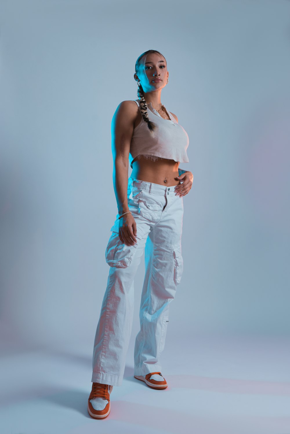 a woman in white pants and a tank top